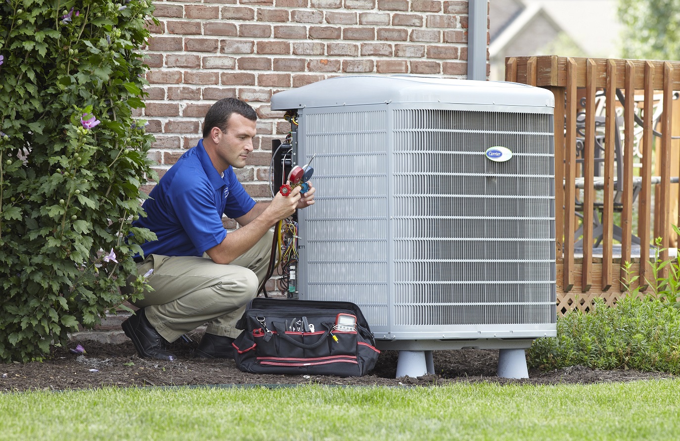 HVAC technician servicing a central AC unit