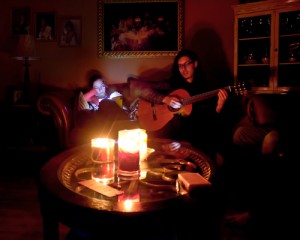 Man playing guitar in candle light