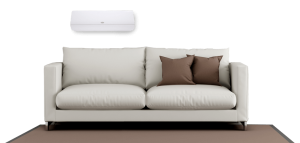 White couch with brown pillows and a ductless unit installed in the wall above.