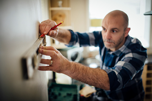 HVAC tech measuring for high velocity heating installation