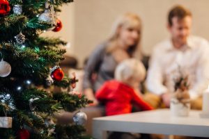 Christmas tree and family in background