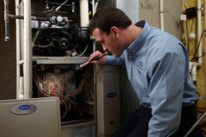 HVAC Technician Inspects Heating and Cooling System