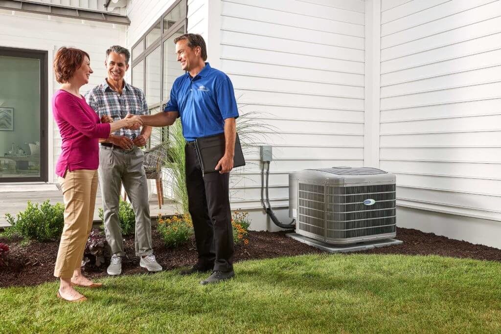 dealer discussing ac options with homeowners outside