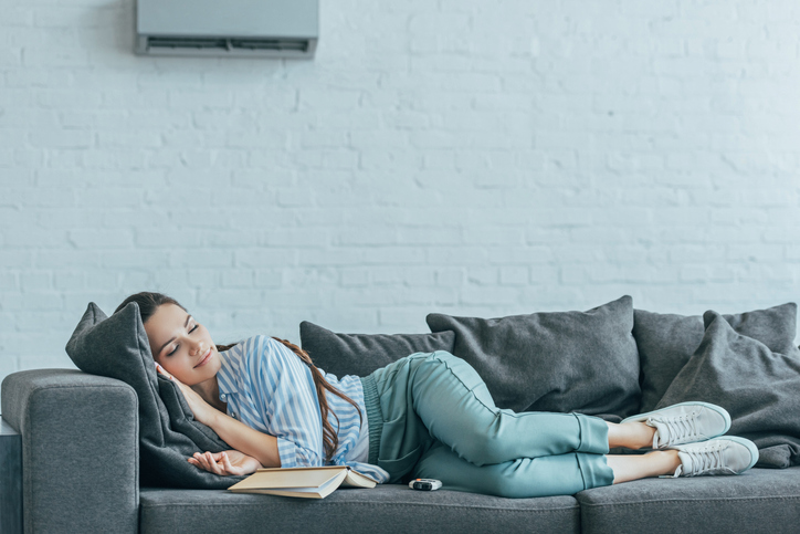 woman napping on a couch enjoying AC