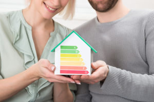 Couple holding a model home