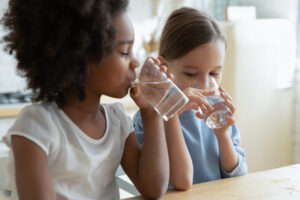 two girls drink water