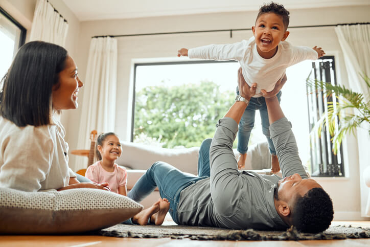 happy family plays together in home