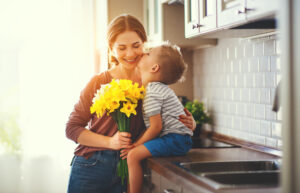 child gives mother spring flowers