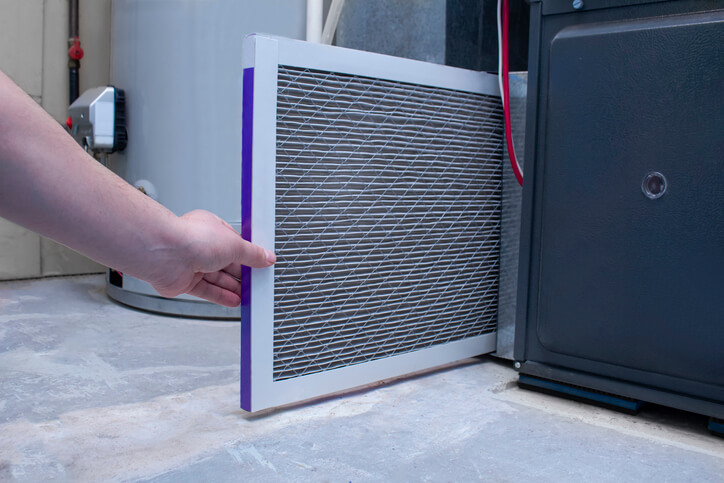 person changing HVAC filter