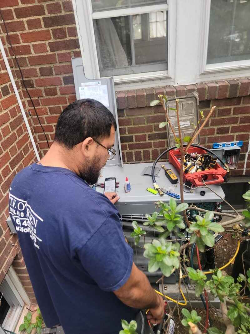 Technician working on an outdoor AC unit