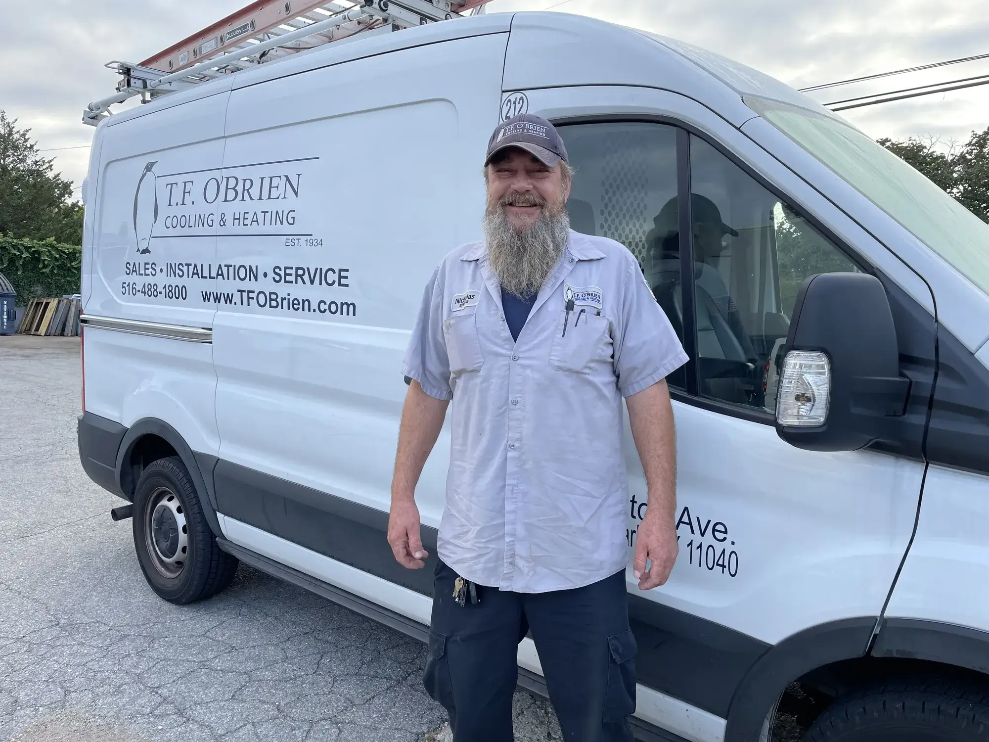 hvac technician in front of truck