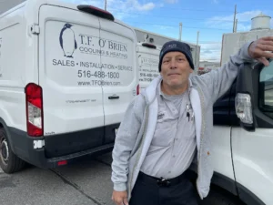 hvac technician in front of truck