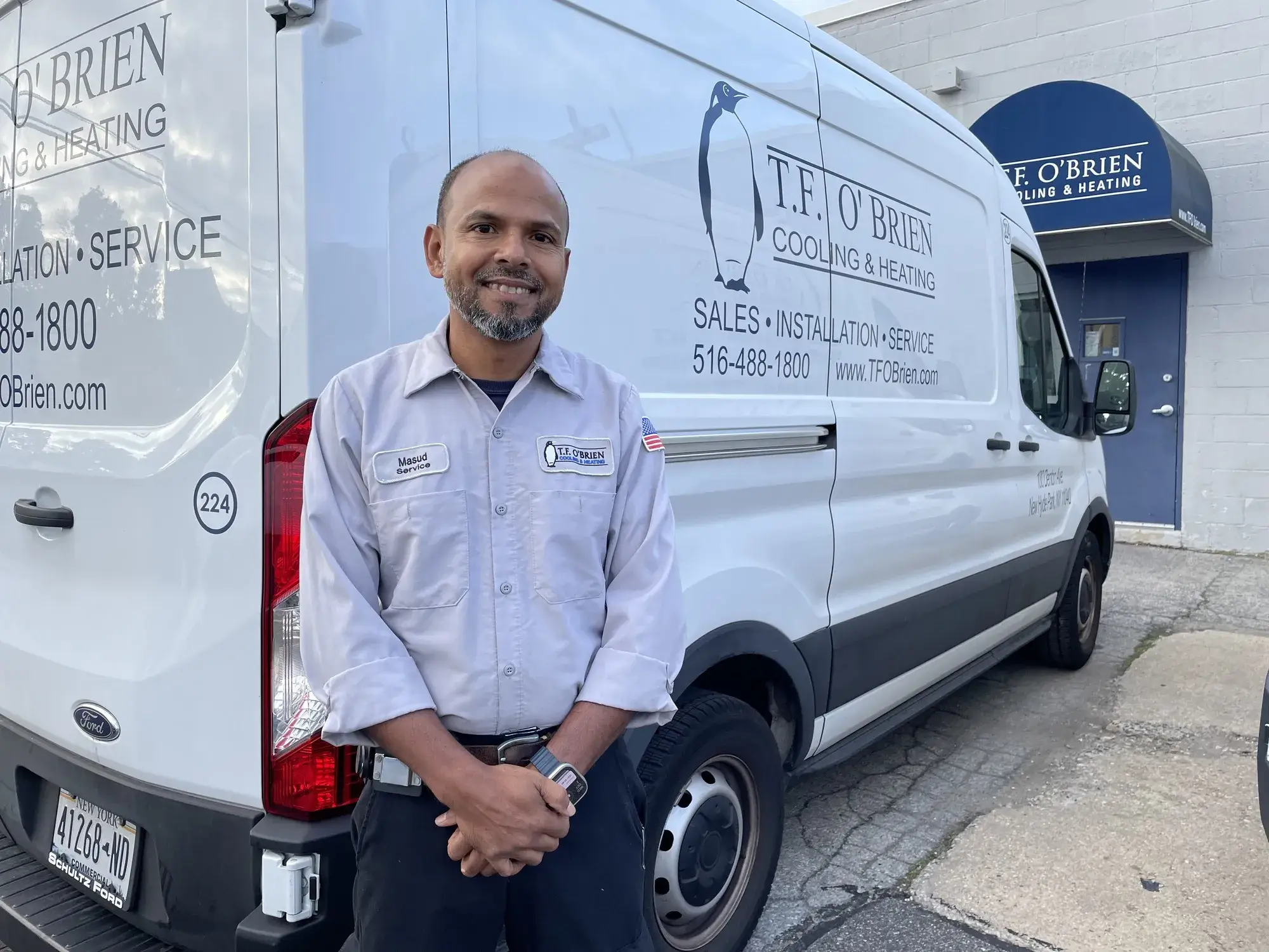 hvac technician in front of truck