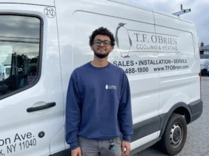 hvac technician in front of truck