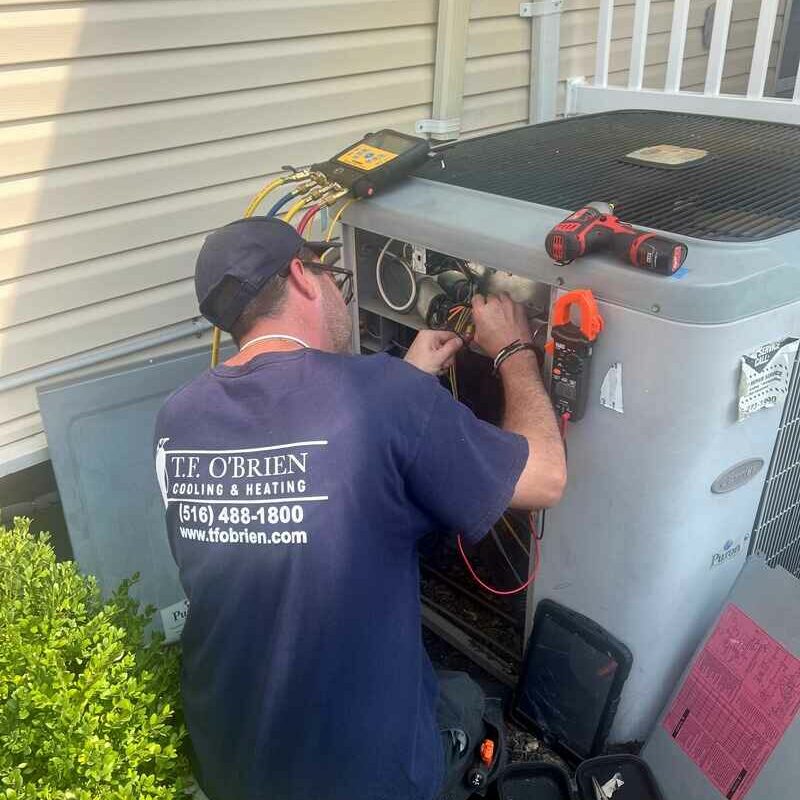 Technician working on a condenser