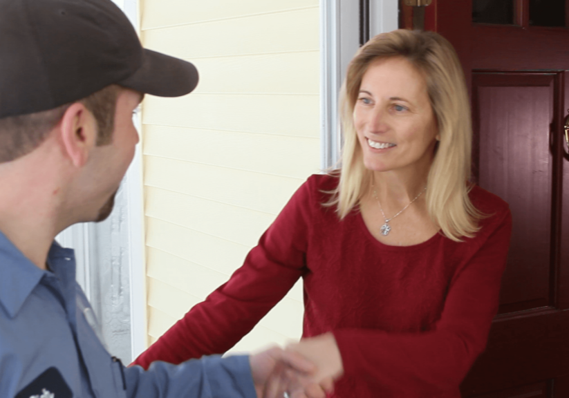 woman greets technician at door
