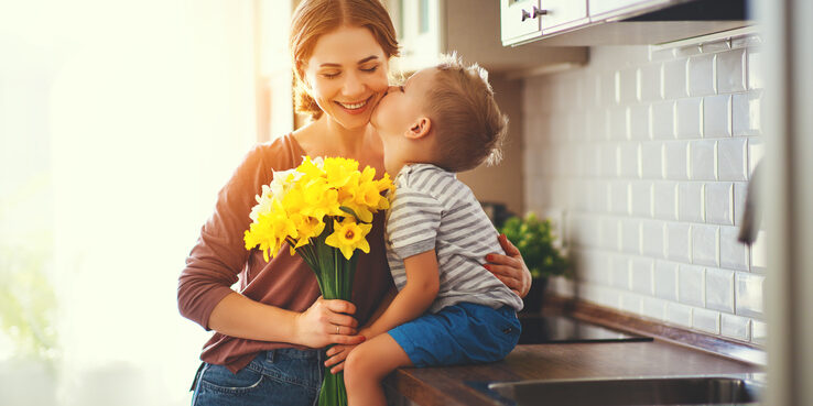 child gives mother spring flowers
