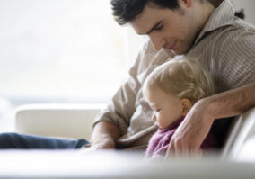 man relaxing with child